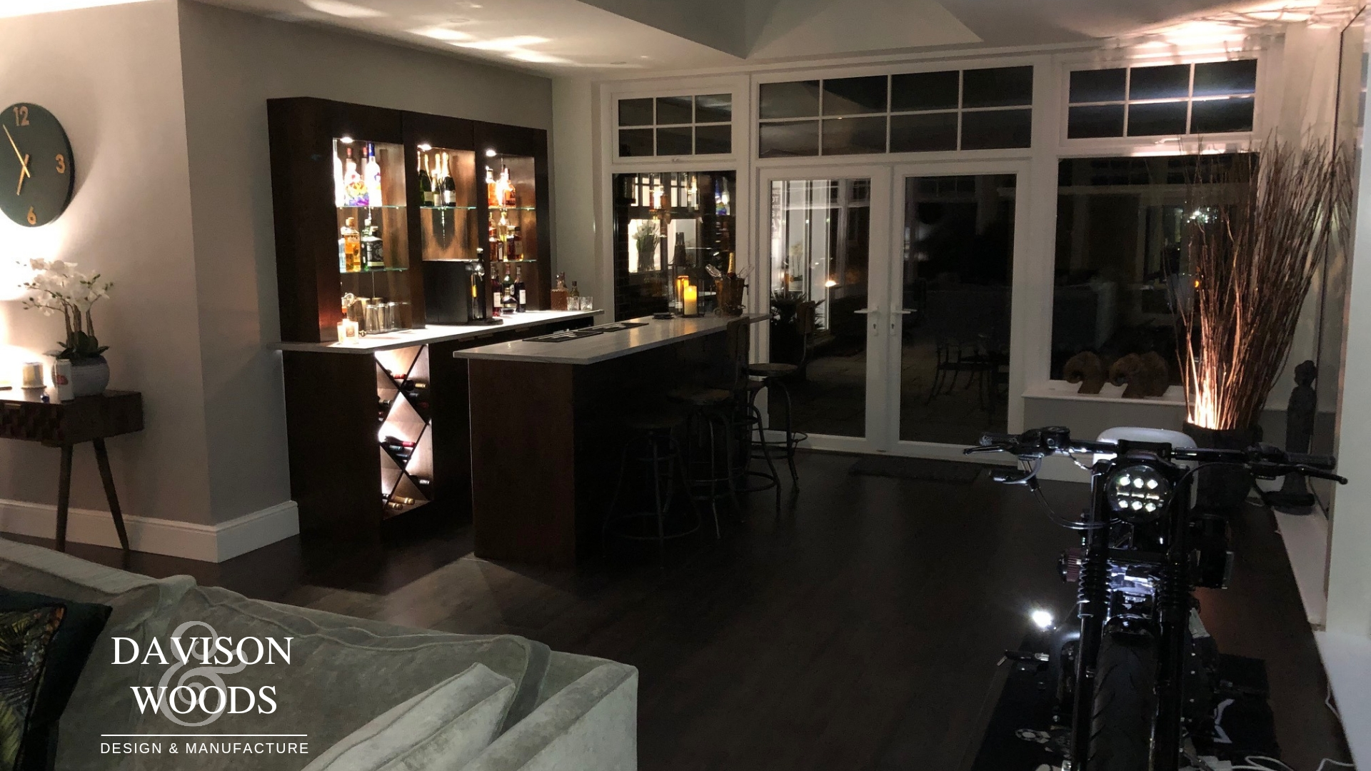 a natural wood bar unit and drinks cabinet with built in lighting in a home