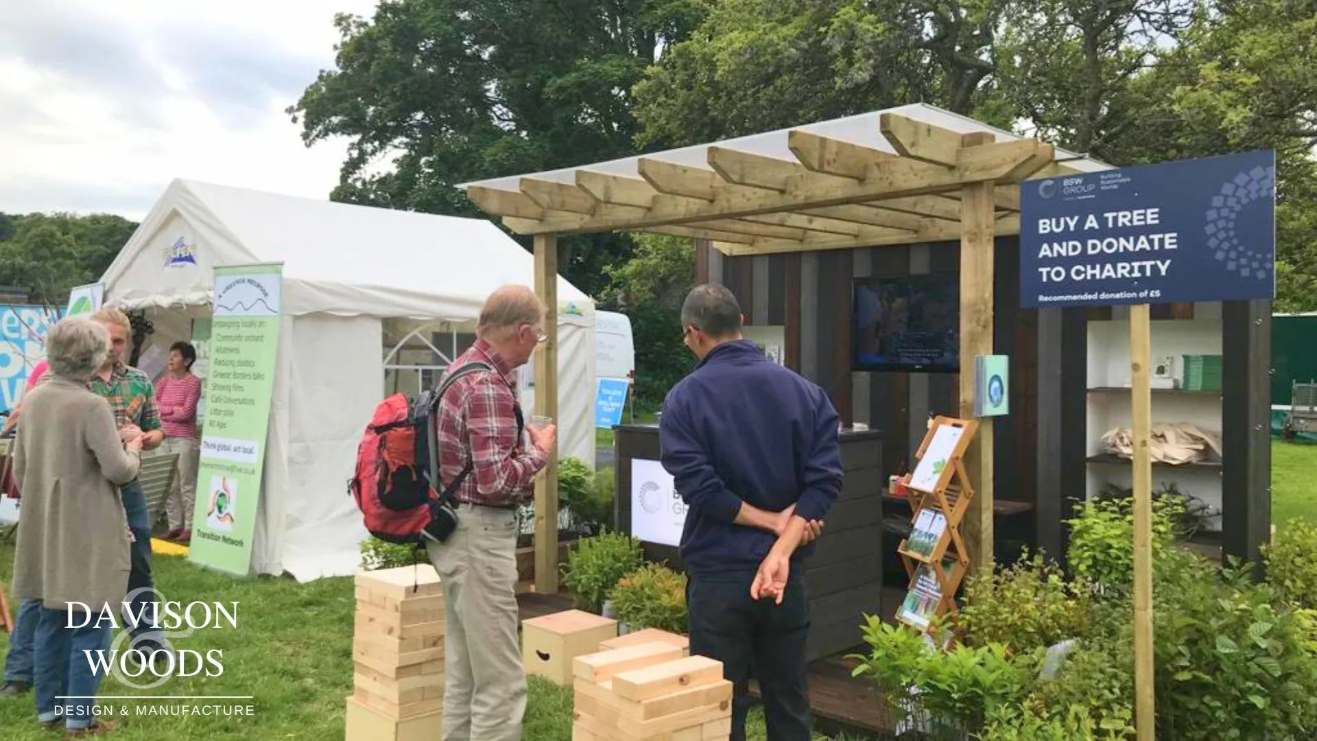 two exhibition attendees looking at the BSW exhibition stand in front of them